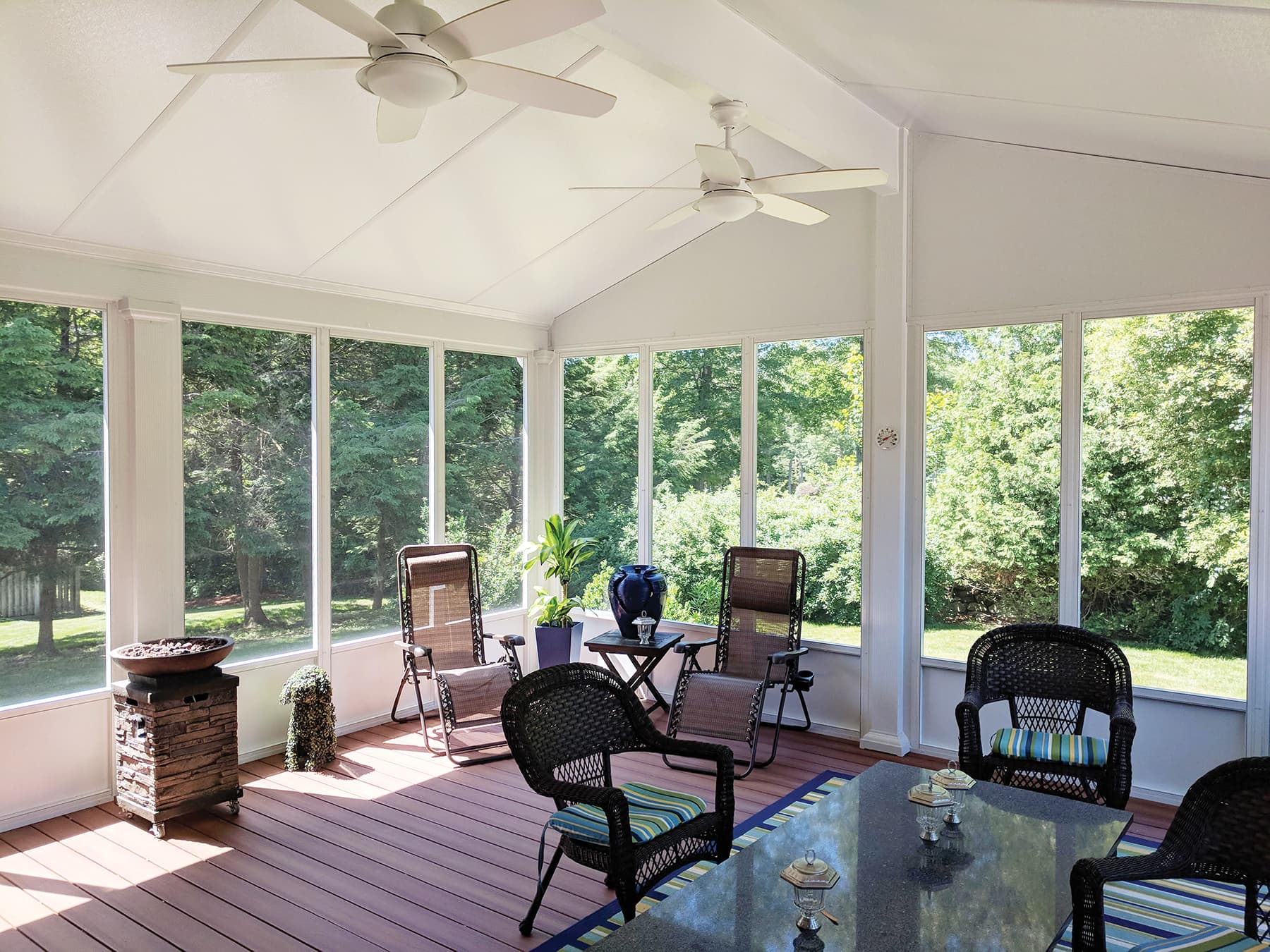 Custom screen room with large screened windows, ceiling fans and outdoor seating in Schenectady